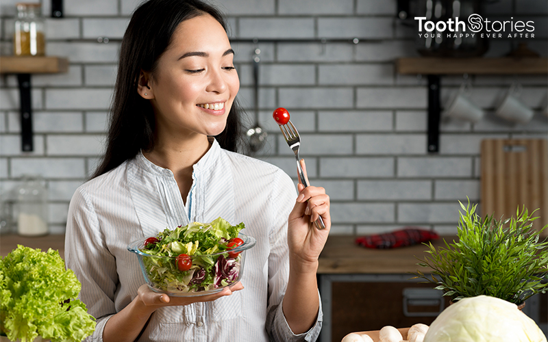 Girl enjoying the bowl of fresh salad